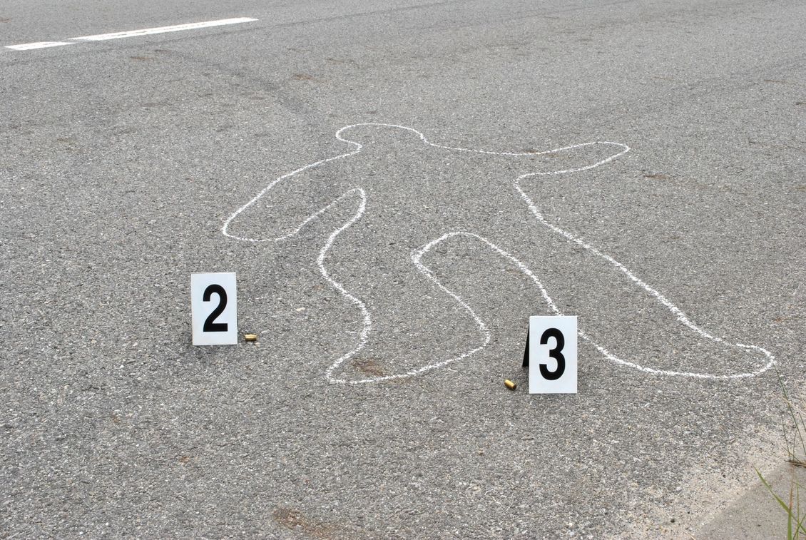 Chalk outline of human body on the street with two ID numbers