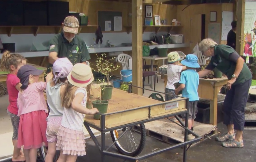 Barb and Neill Simpson working with children on plants