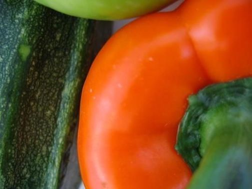 Close up of a courgette (zucchini) and a red pepper (capsicum)