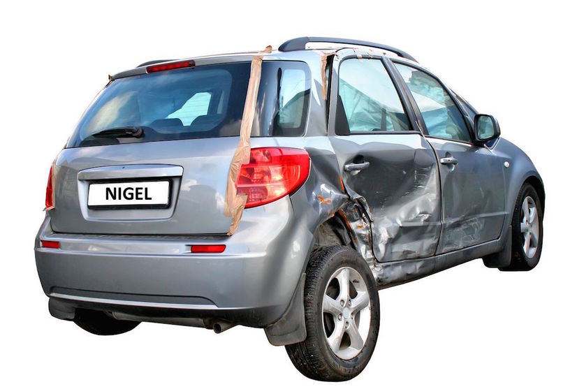 Damaged small silver car on white background.