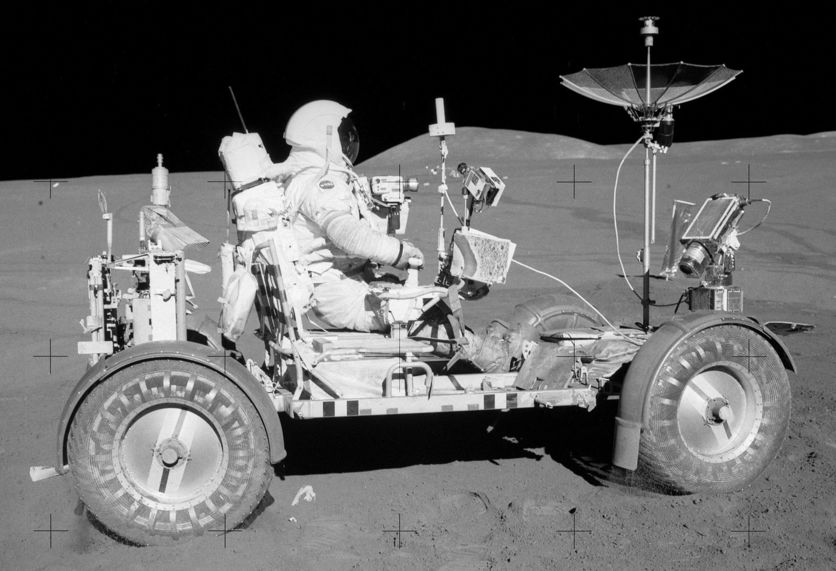 Apollo Lunar Rover with equipment and astronaut driving.