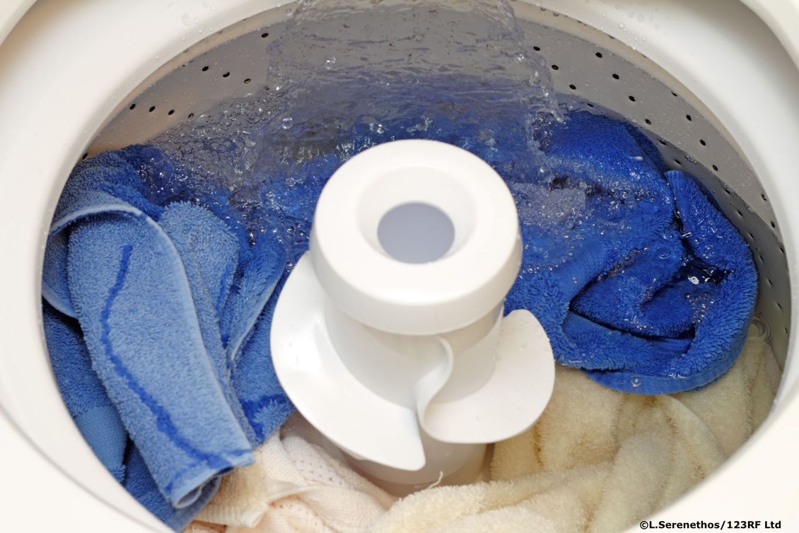 Blue and white clothes in a top loader washing machine.