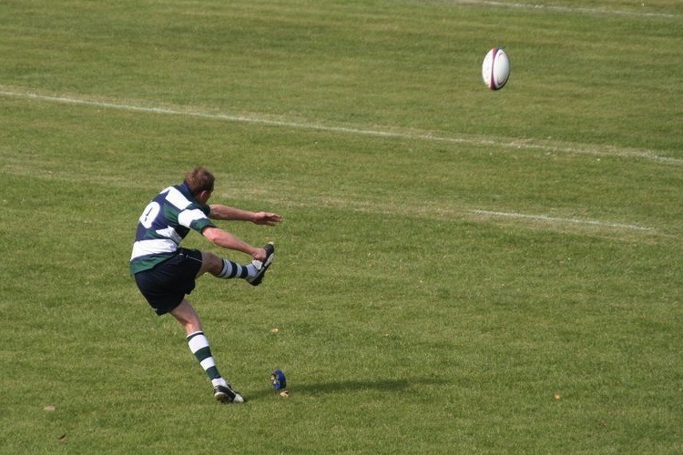 Odessa National Championship rugby, player kicking a ball.
