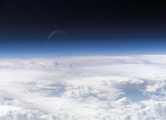 View looking down from Earth's atmosphere at clouds.