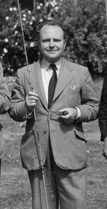 Professor Walker in a suit with fishing rod and pipe, 1950s