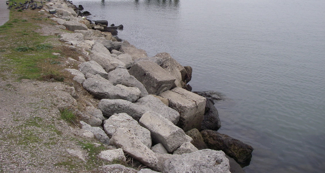 Riprap (rock, concrete rubble) by a river for erosion protection