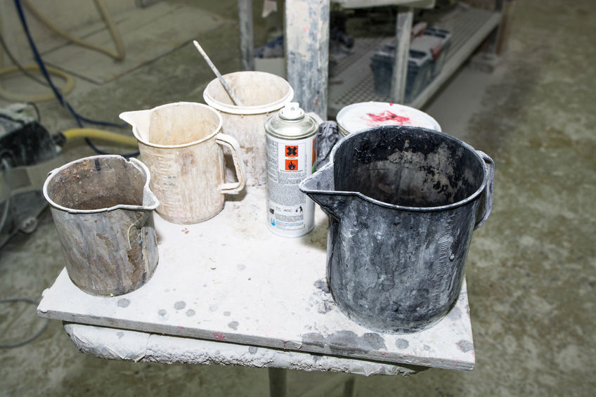 dirty painting equipment and jugs.