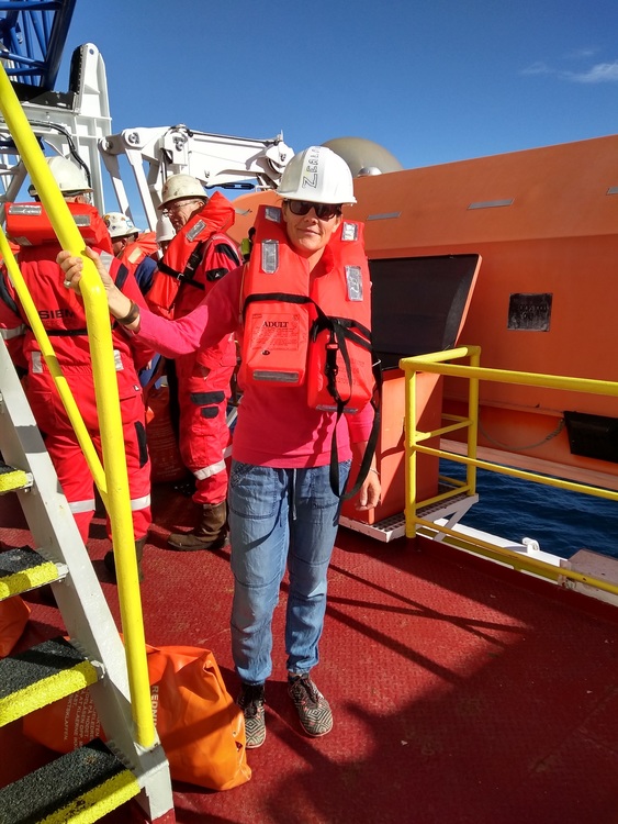 Woman in life jacket during a lifeboat drill on board a ship