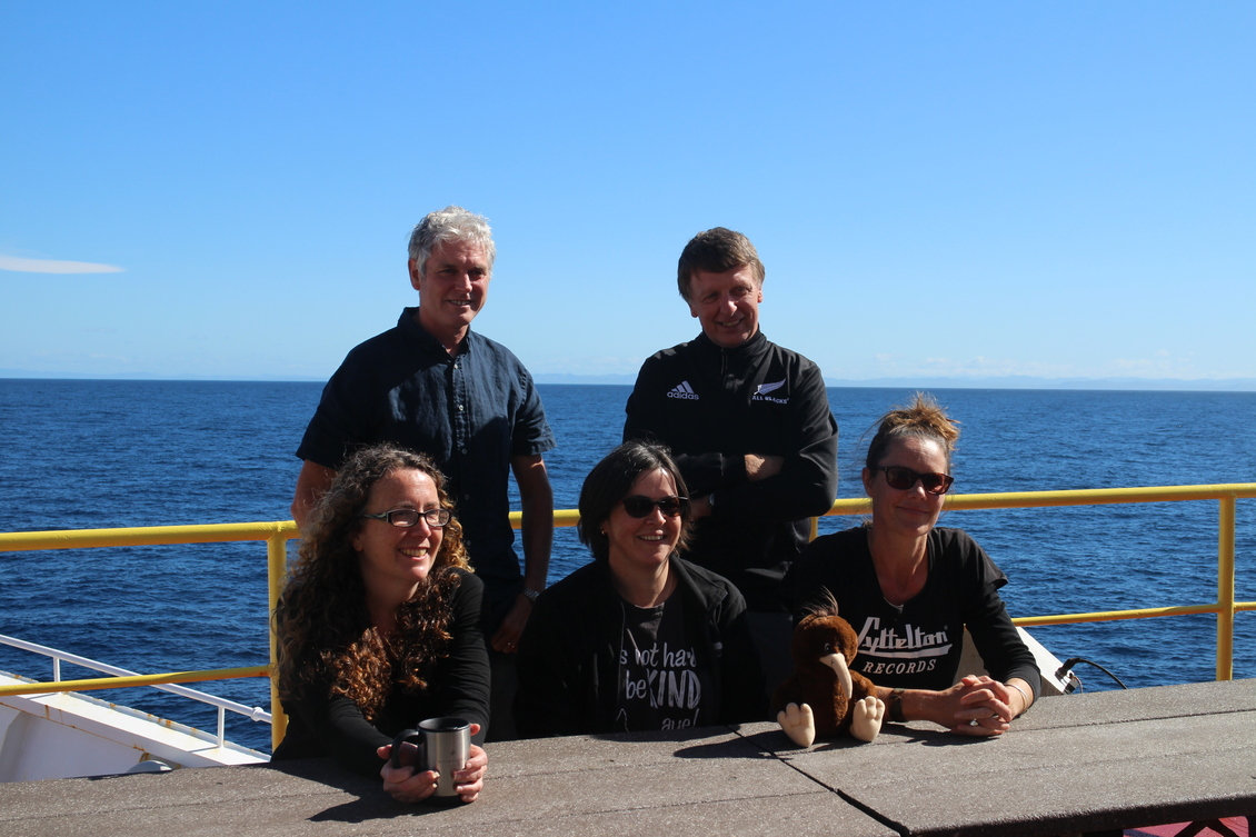 5 New Zealand scientists aboard research ship in the sun.