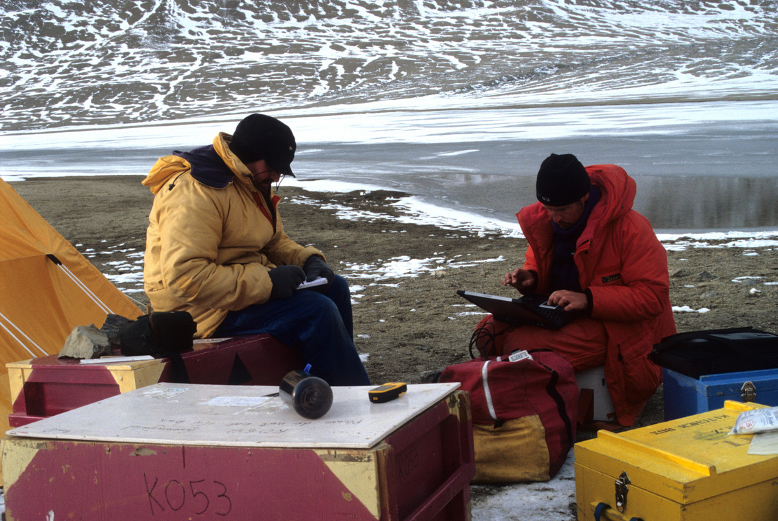 2 Scientists recording data outside in Antarctica