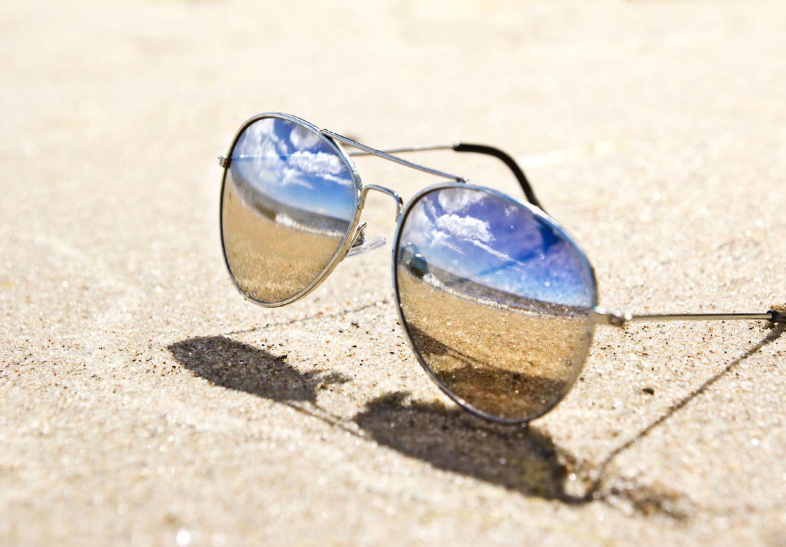 A pair of Polarised sunglasses on ground.