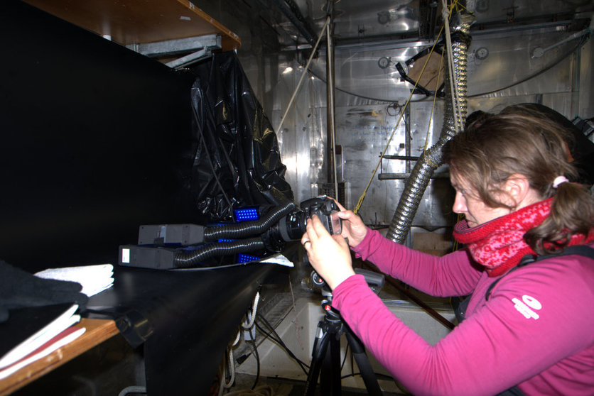 Artist Gabby O’Connor working in a field container in Antarctica