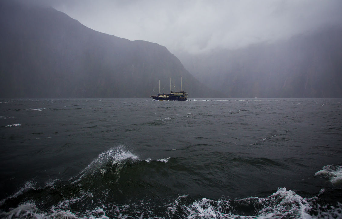 Boat at Milford Sound, New Zealand on a foggy day