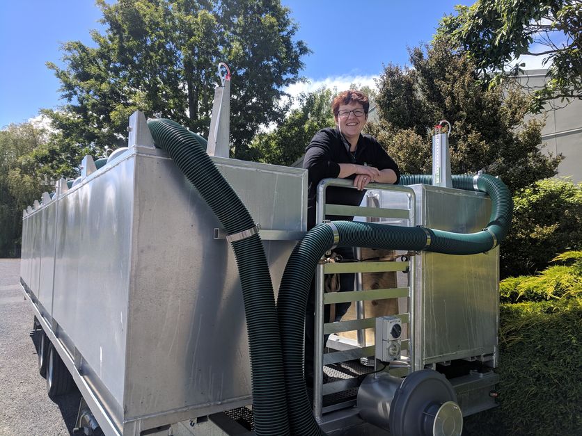 Scientist on a trailer of portable accumulation chambers (PACs).