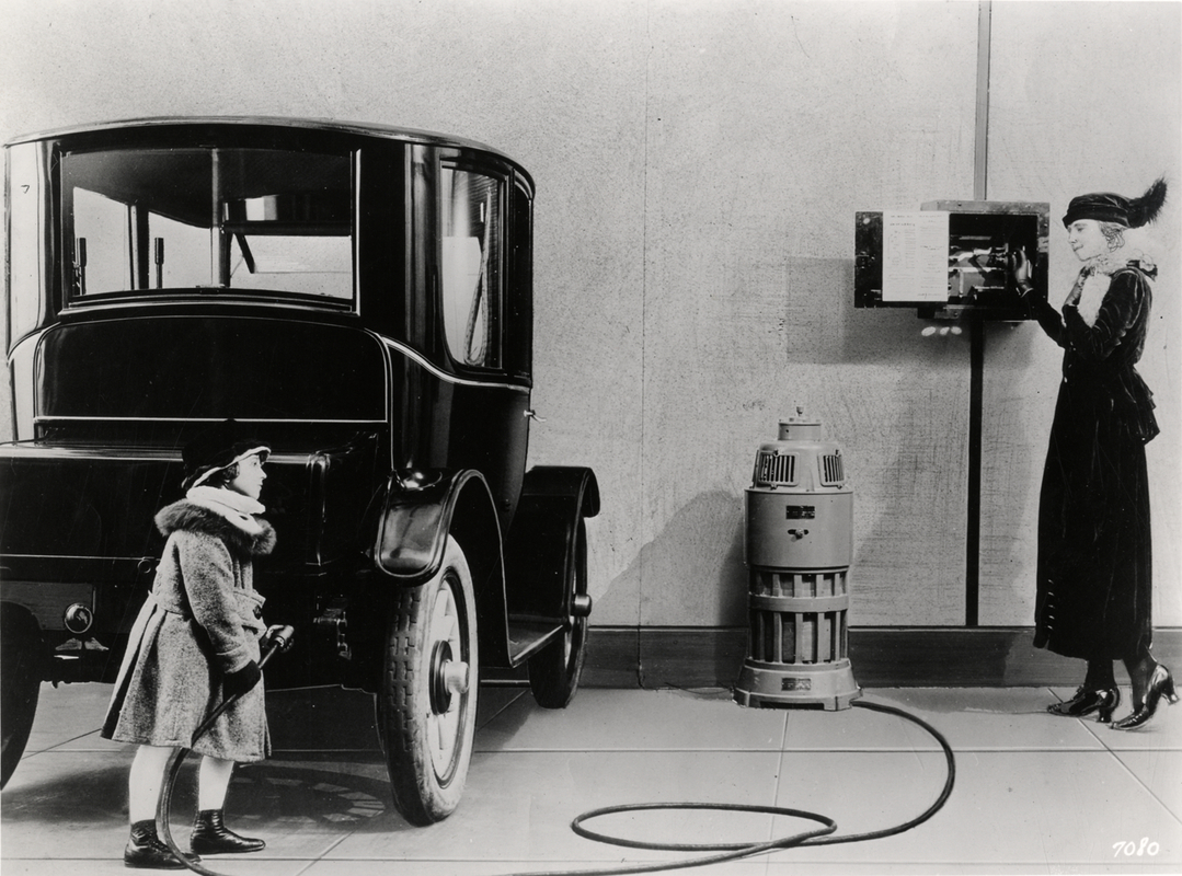 Woman and child, Charging a Baker electric car in 1914
