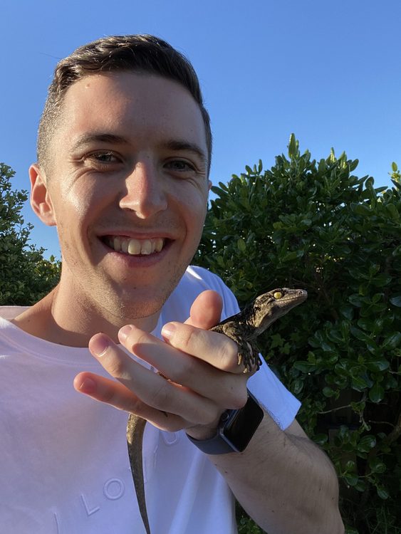 University Masters student Lachie Scarsbrook holding a gecko