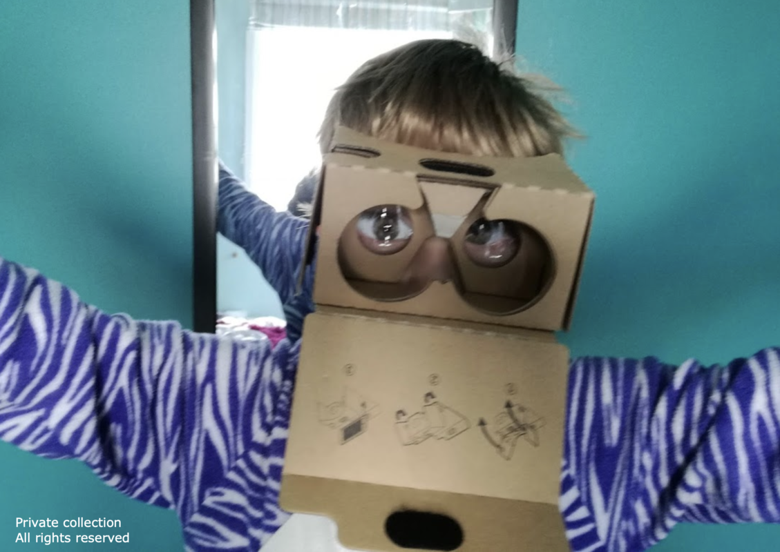 Child with 3D cardboard glasses on doing drama.