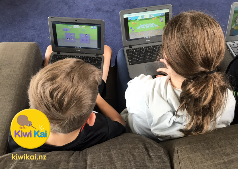 Two students playing Kiwi Kai’s virtual farm on laptops