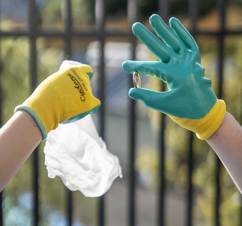 Close up of two gloved hands holding litter
