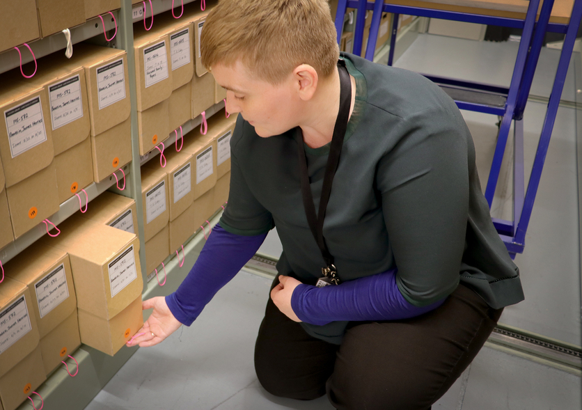 Rauhina Scott-Fyfe with many archive boxes 