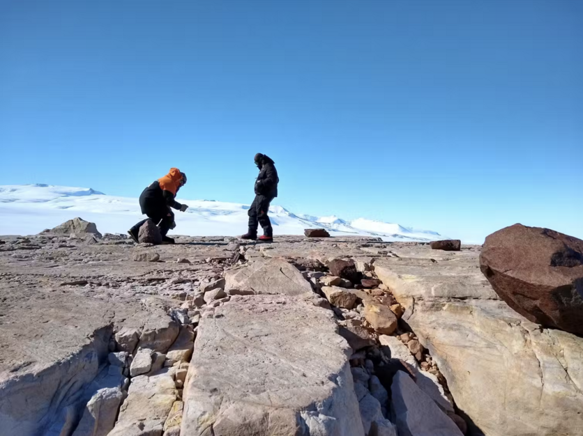 Two Scientists on rocky outcrop in Antarctica