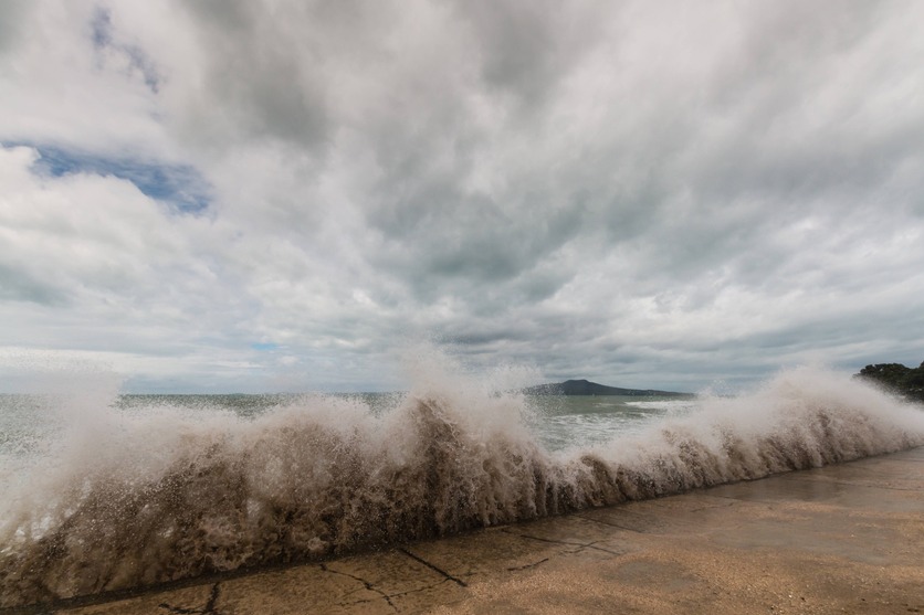 Ocean waves breaking on a sea wall in New Zealand