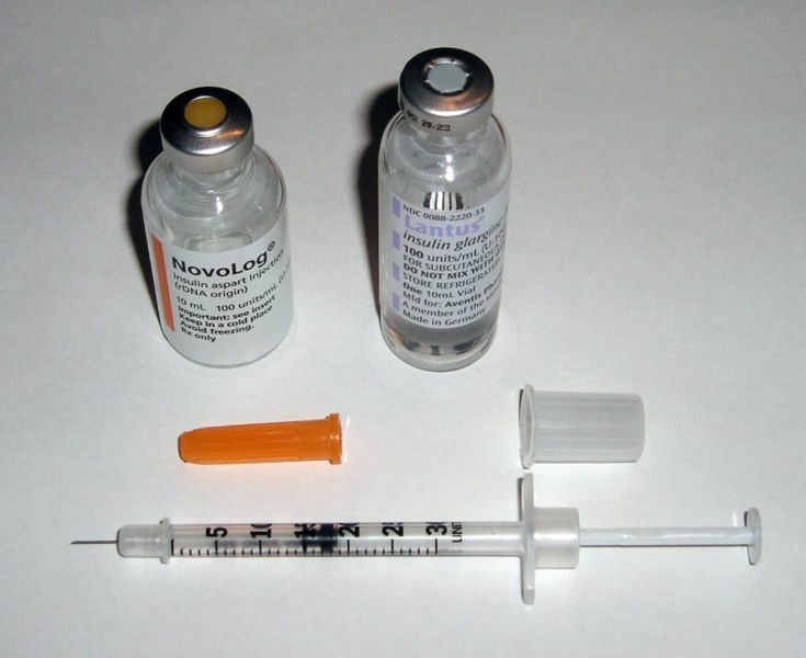 Two insulin vials and a syringe.